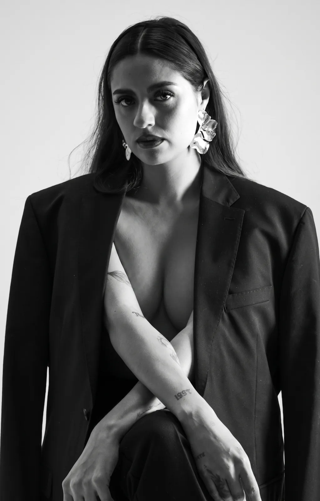 Andrea Maldonado in a black blazer, black-and-white studio portrait